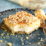 Bite missing from slice of Caramel Pecan Shortbread No-Bake Cheesecake