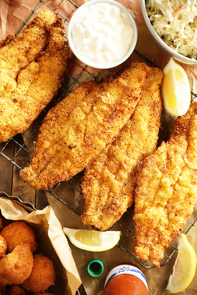 Pieces of Lemon Pepper Fried Catfish with lemons