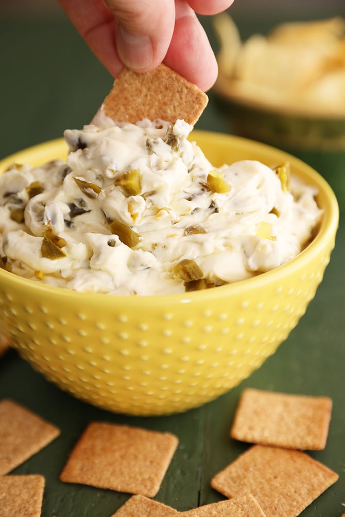 Dipping cracker into candied jalapeno dip