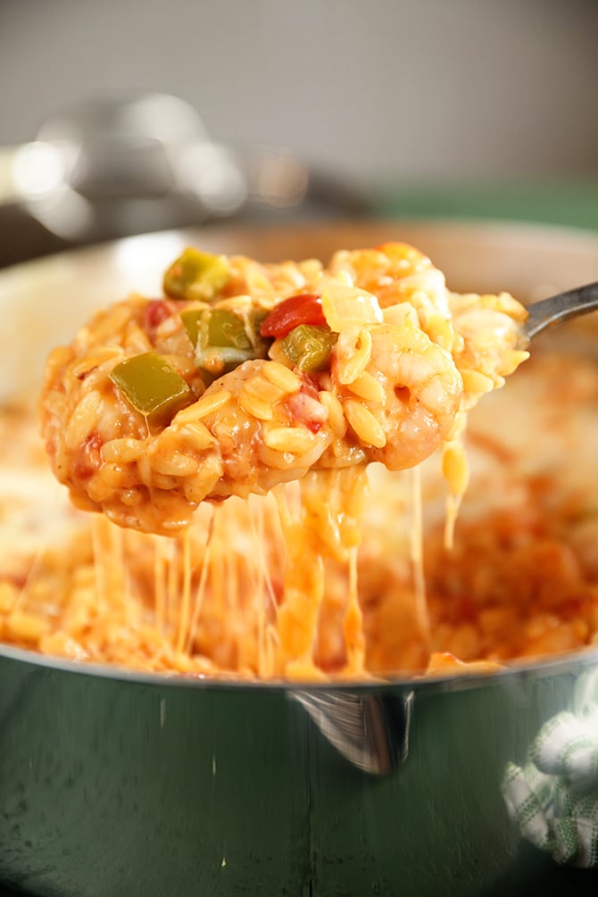 Spoonful of Cheesy Shrimp and Orzo Skillet with cheese pull