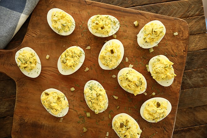 Dill Pickle Deviled Eggs on cutting board