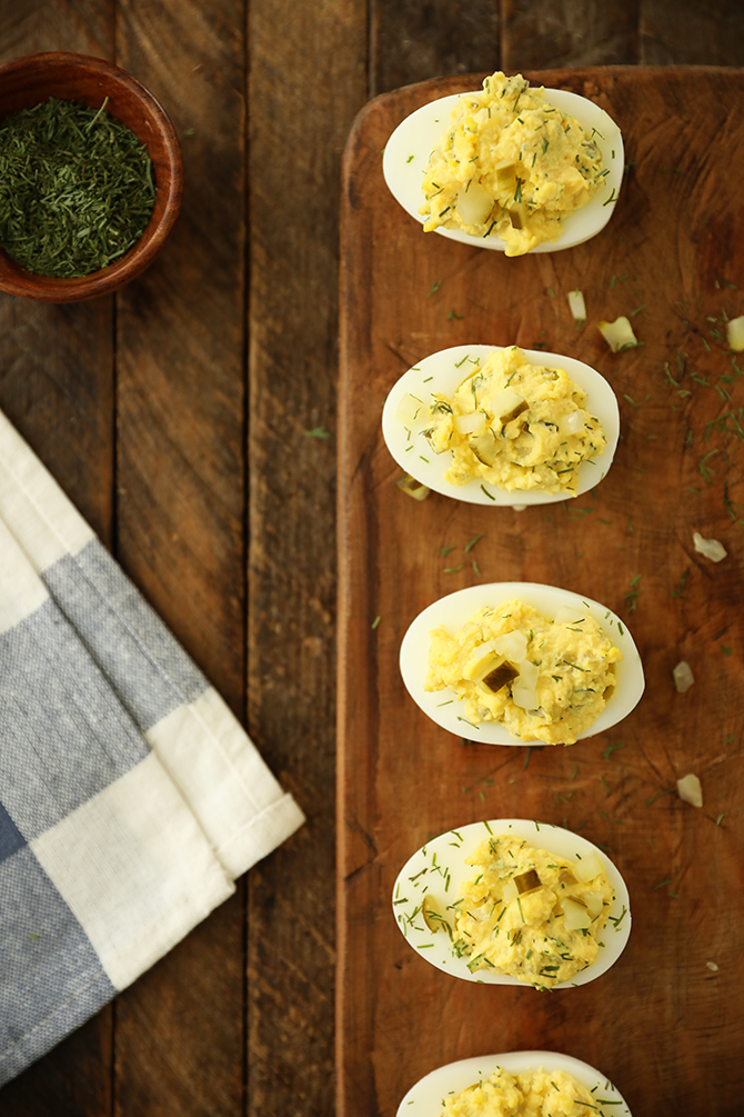Dill Pickle Deviled Eggs on cutting board