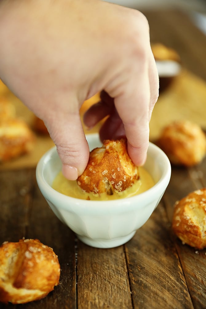 Canned Biscuit Pretzel Bite being dipped into honey mustard