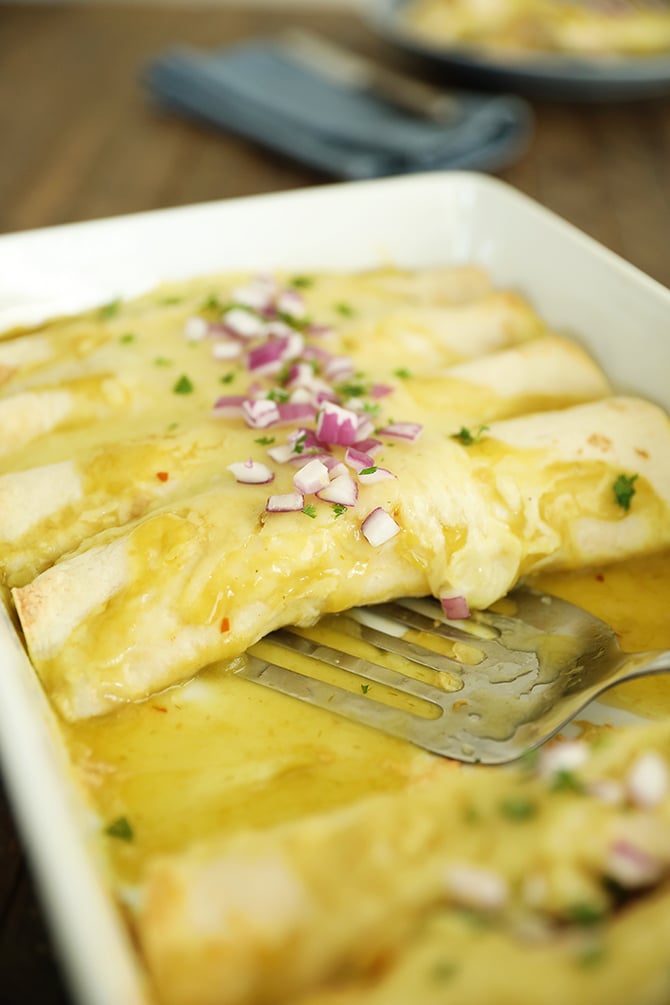 Creamy Chicken Enchiladas in a white dish