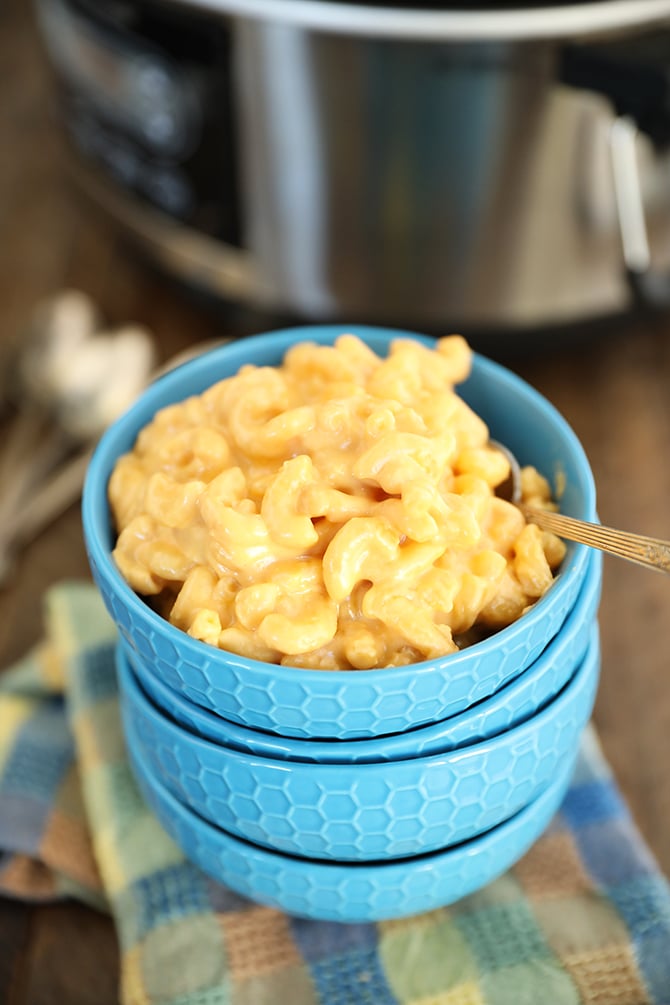 The Best Crock Pot Mac and Cheese in a stack of blue bowls
