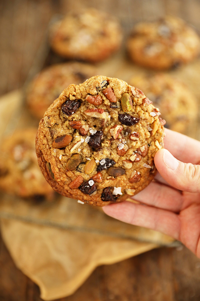 Single Chocolate, Cherry, Pistachio, Pecan Cookie in hand