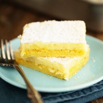 Two Easy Lemon Squares stacked on a blue plate