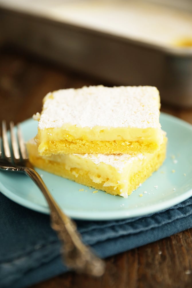Two Easy Lemon Squares stacked on a blue plate