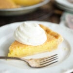 Slice of Old Fashioned Vinegar Pie with whipped cream on top
