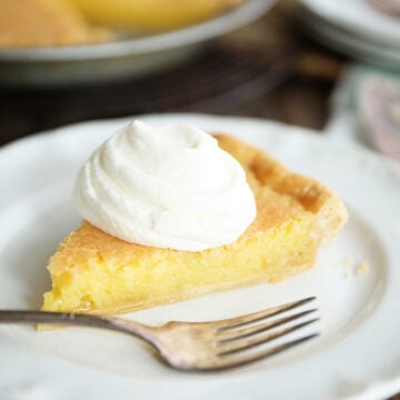 Slice of Old Fashioned Vinegar Pie with whipped cream on top
