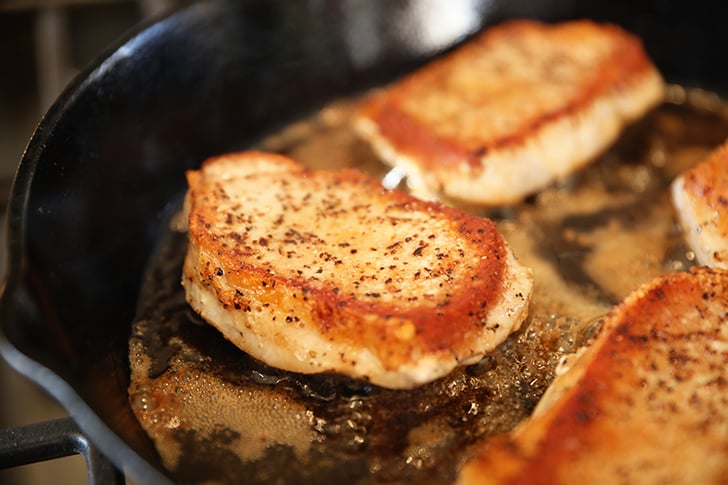 cooked pork chops in skillet