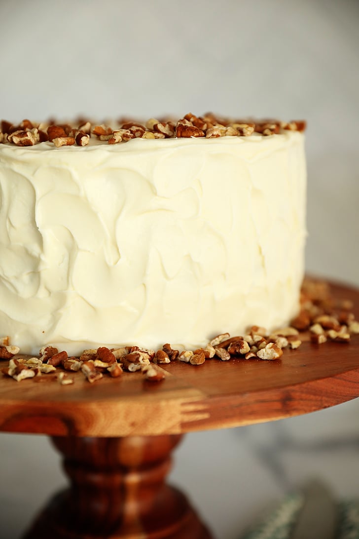 Whole carrot cake on cake stand.