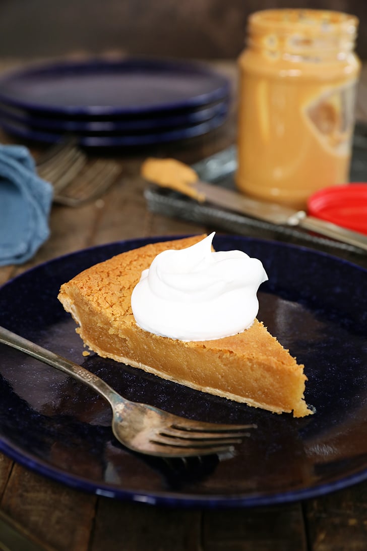 single slice of Peanut Butter Chess Pie with whipped cream.