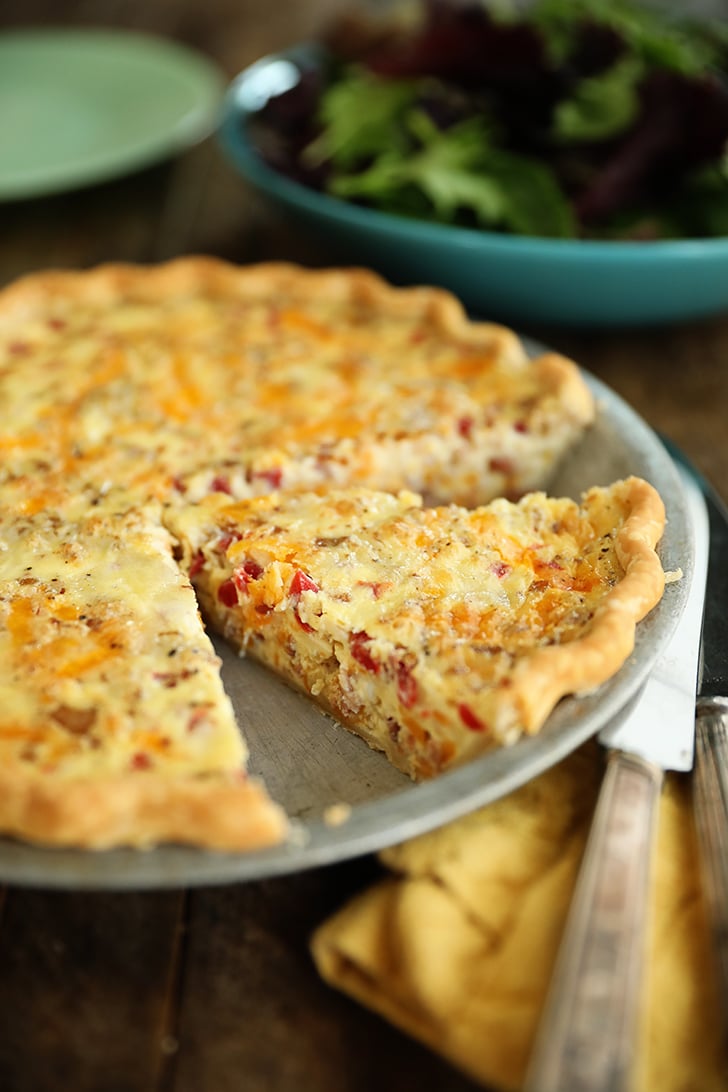 Bacon and Pimento Cheese Quiche with slice cut.