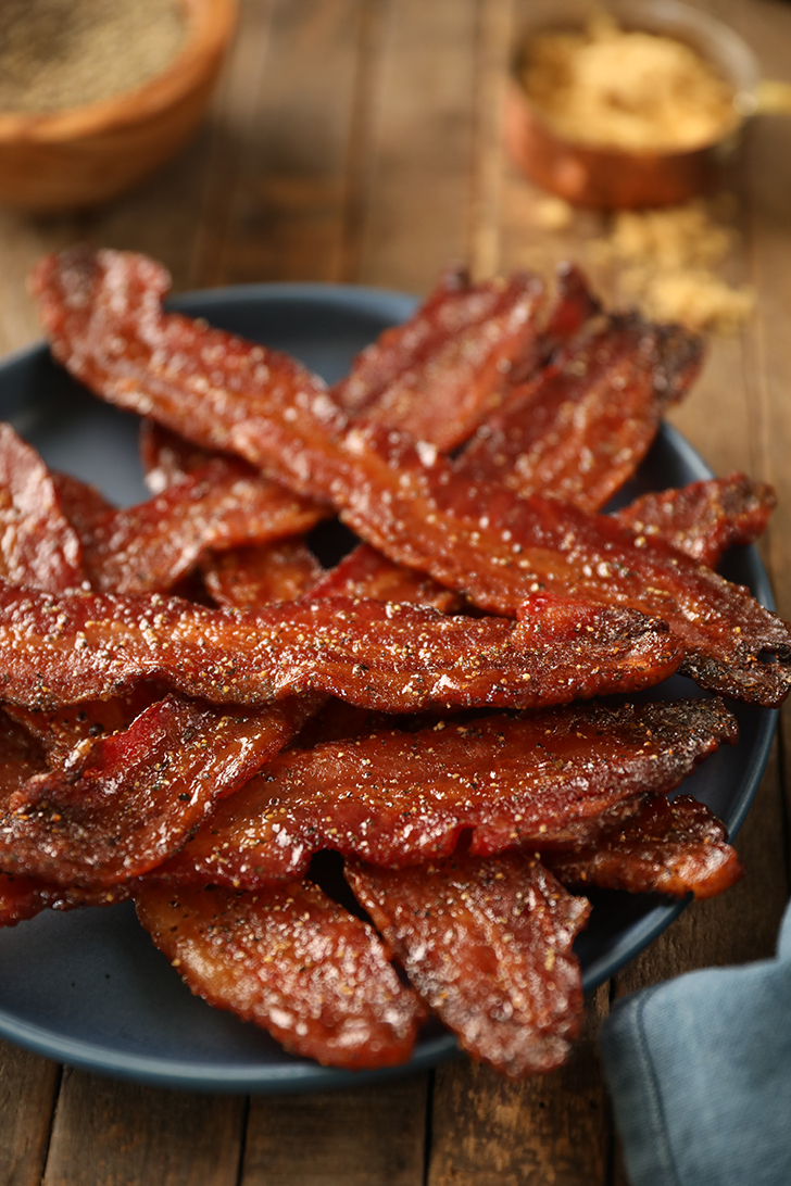 Easy Candied Bacon pieces on a blue plate.