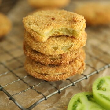 stack of fried green tomatoes with bite missing from one.