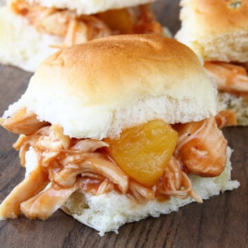 Slow Cooker Pineapple Chicken Sliders on a board.