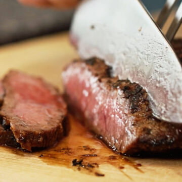 slicing skirt steak against the grain.
