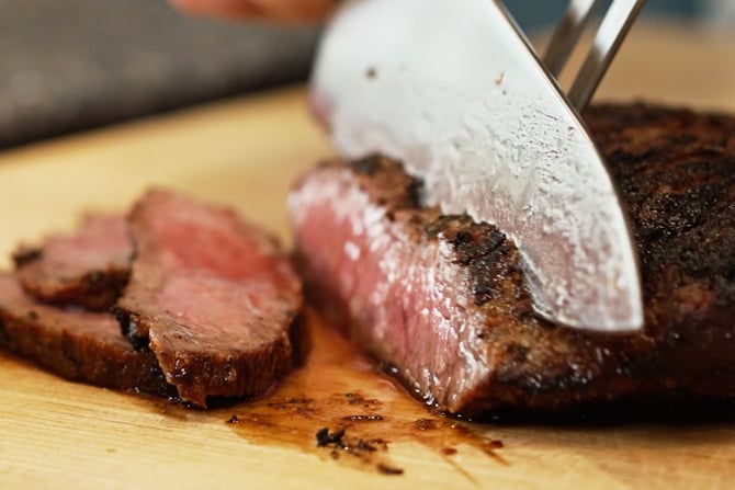 slicing skirt steak against the grain.