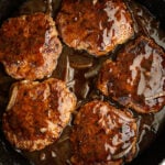 Salisbury Steak in a skillet.