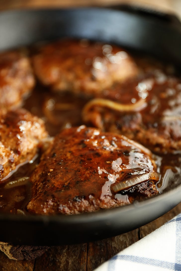 Salisbury Steaks in a skillet.