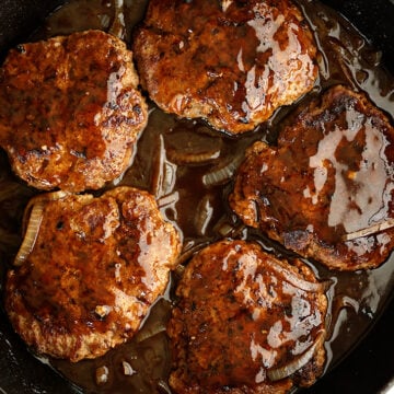 Salisbury Steak in a skillet.