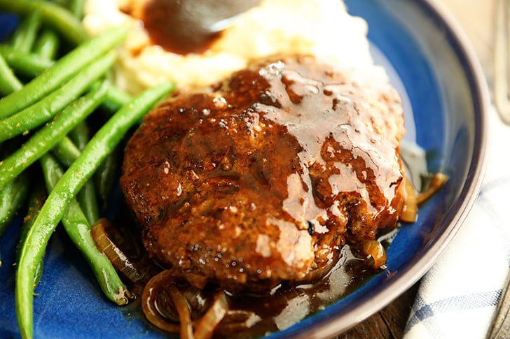 Salisbury Steak on a plate with mashed potatoes.