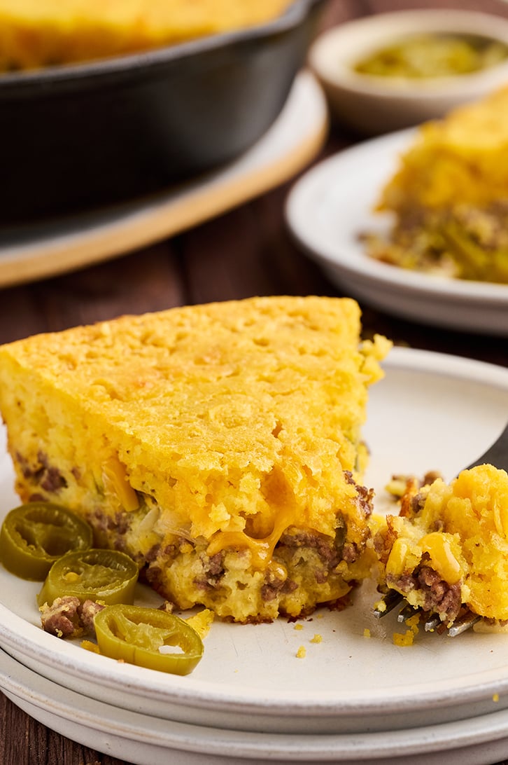 Bite taken from slice of Mexican Cornbread.