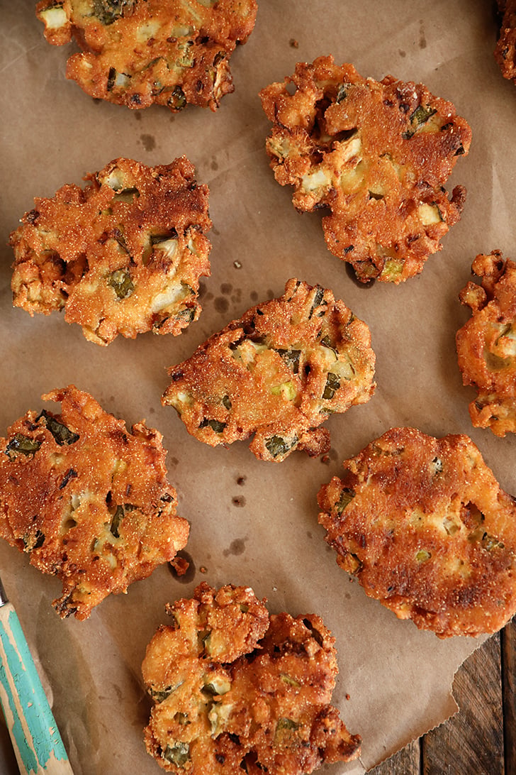 Fried Pickle Fritters on brown paper.