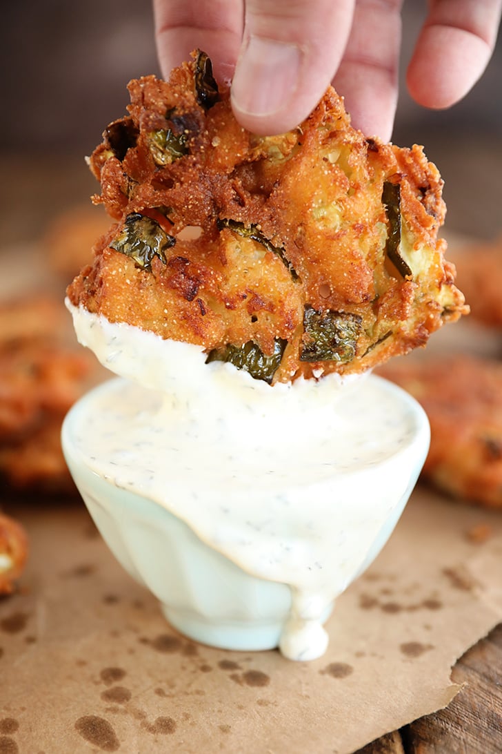 Fried Pickle Fritter being dipped in ranch.