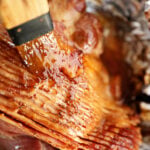 Brown Sugar Pineapple Ham Glaze being brushed over ham.