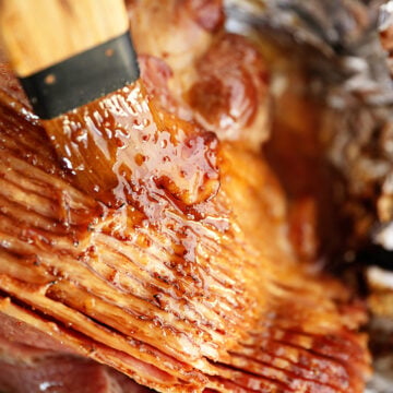 Brown Sugar Pineapple Ham Glaze being brushed over ham.