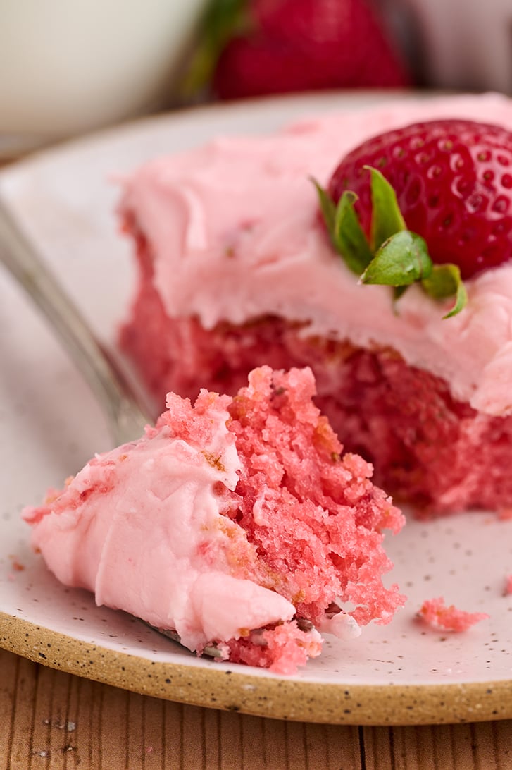 Bite missing from Strawberry Sheet Cake.