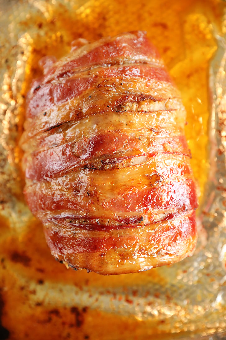 Overhead view of pork loin wrapped in bacon.