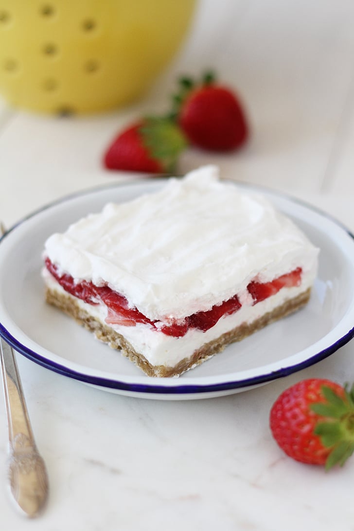 Slice of Strawberry Delight on plate with blue rim.