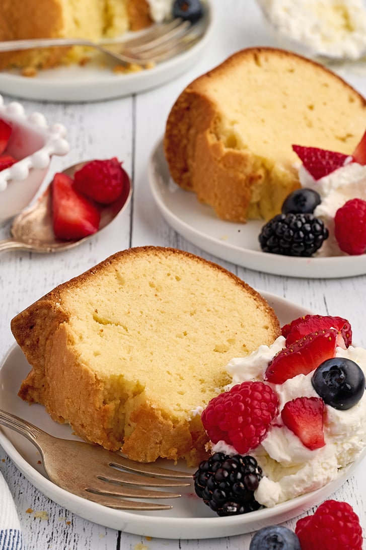 Slices of Cream Cheese Pound Cake on white plates.