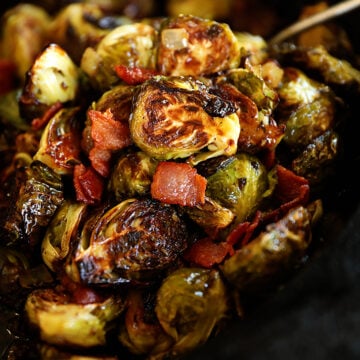 roasted Brussels sprouts with bacon in cast iron skillet.