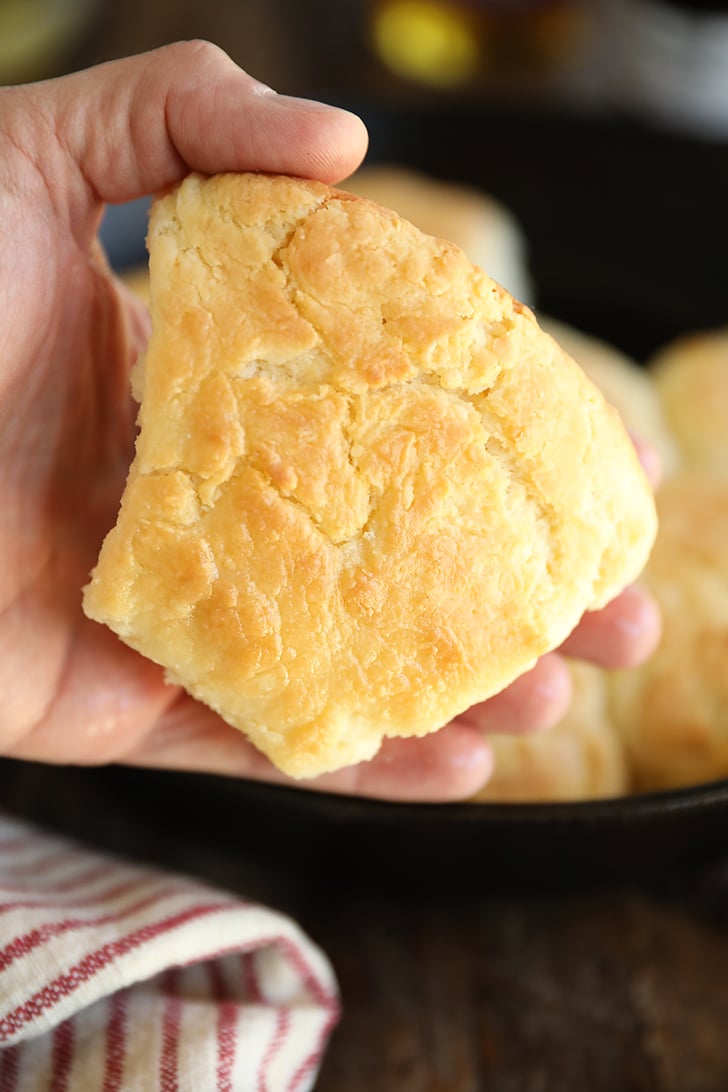 Holding a cathead biscuit in hand.