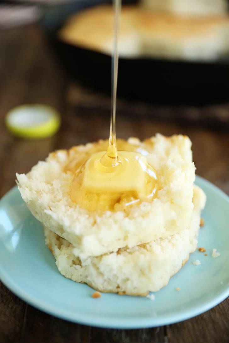 Biscuit with syrup being poured on it.