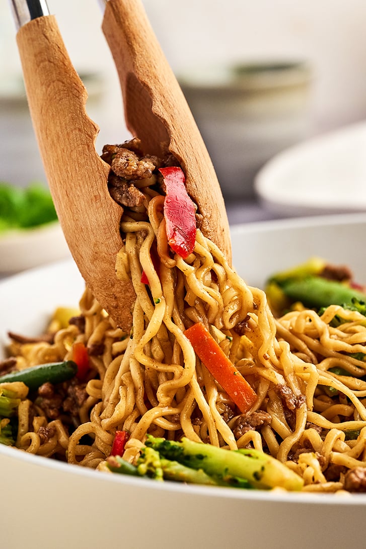Tongs with ramen.