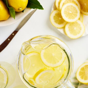 Overhead view of lemonade in pitcher with lemons.