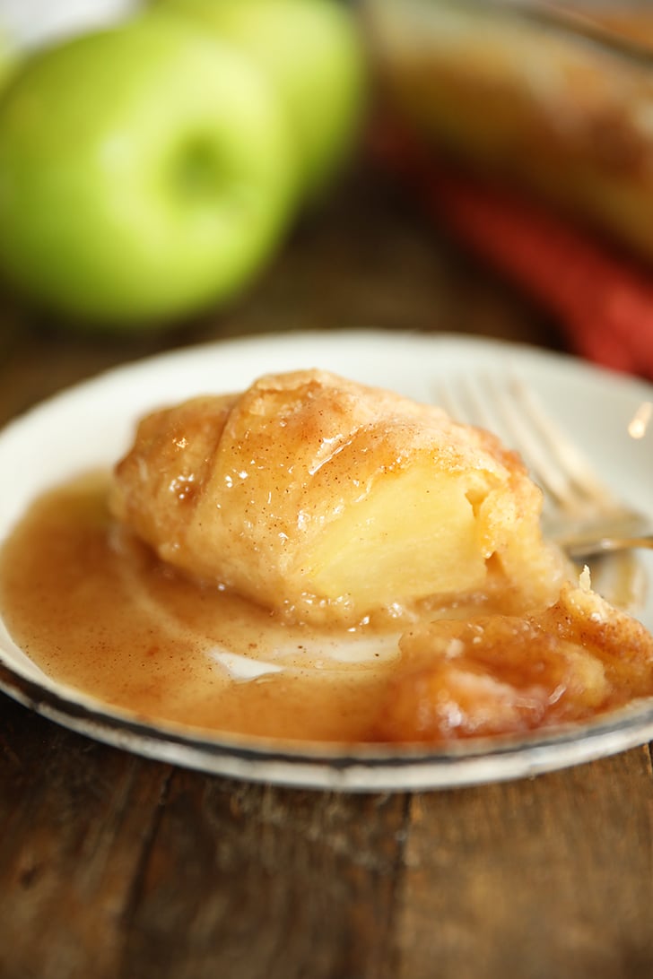 Apple dumpling on plate with bite missing.