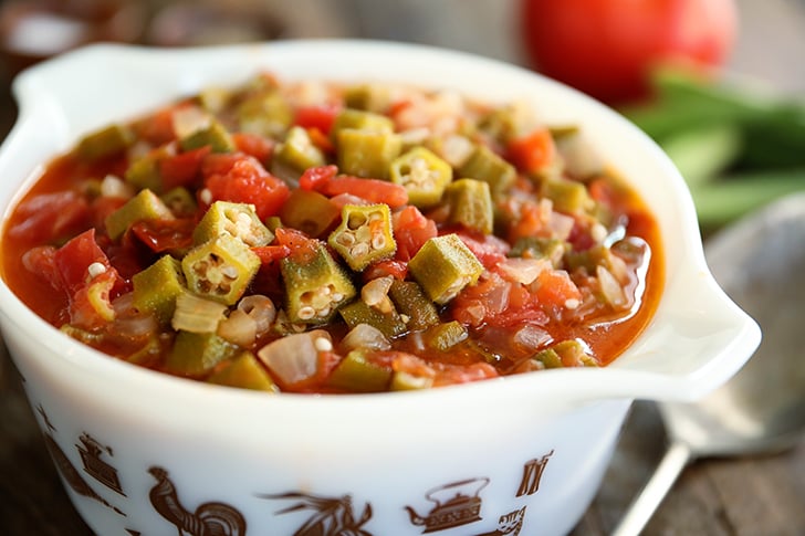Okra and Tomatoes in a white bowl.