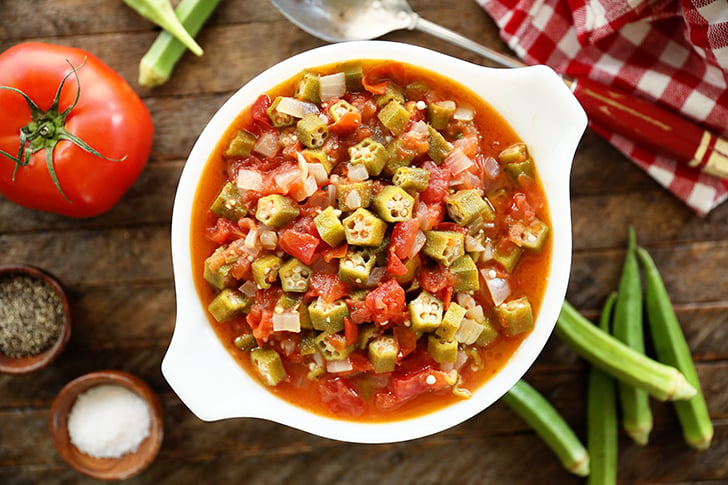 Okra and Tomatoes in a white bowl.