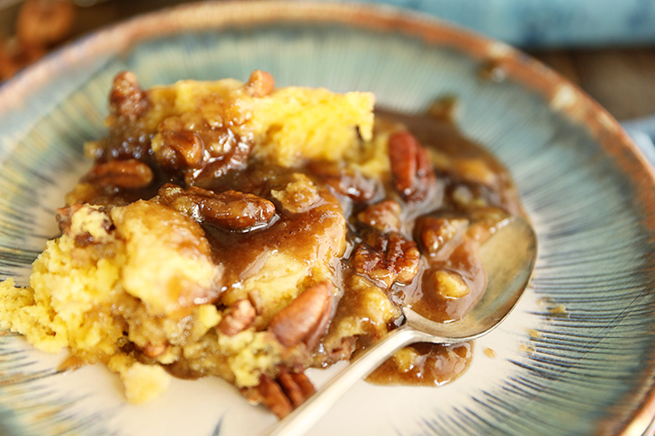 Pecan Pie Cobbler on blue plate.