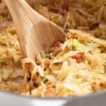 Shortcut Skillet Cabbage and Bacon Served with a Spoon.