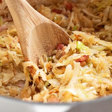 Shortcut Skillet Cabbage and Bacon Served with a Spoon.