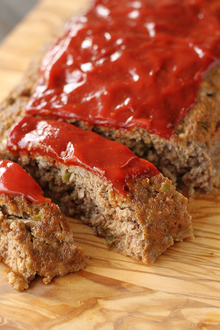 Sliced meatloaf on a cutting board.