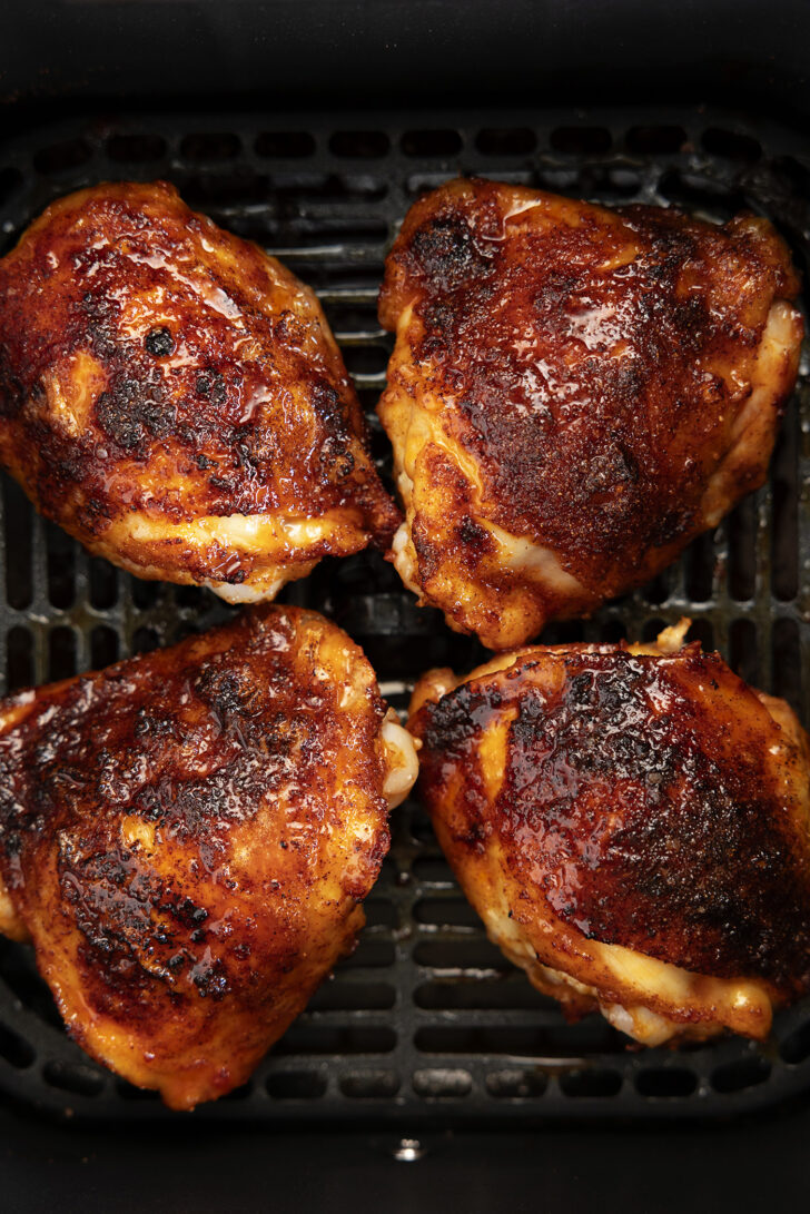 Chicken thighs in an air fryer with hot honey glaze.