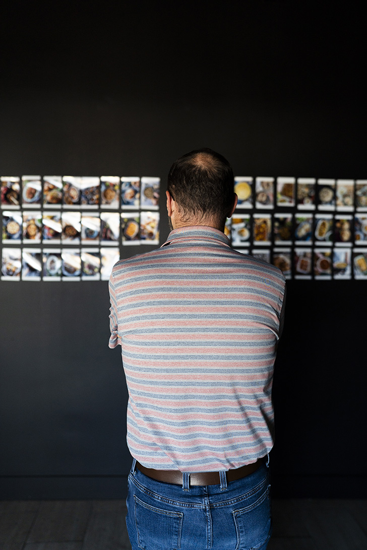 Stacey looking at images on wall.